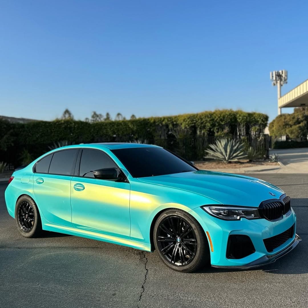 Teal-to-gold color-flip BMW sedan wrap