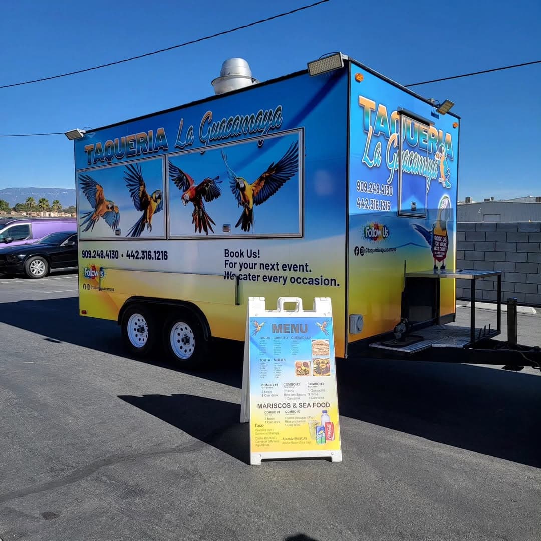 Taqueria La Guacamaya food truck wrap with bold parrot illustrations