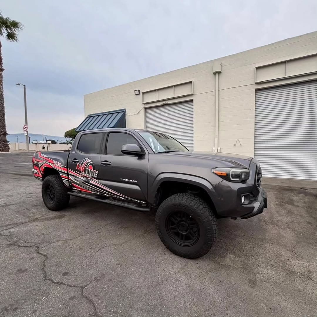 Mr Tire grey Toyota Tacoma fleet vehicle with red graphics